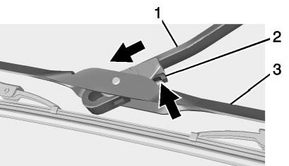 2. Push the release lever (2) to disengage the hook and push the wiper arm (1)