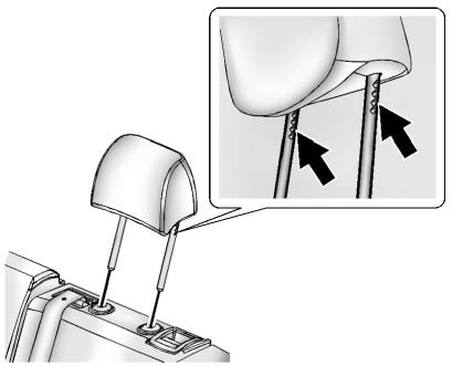 1. Insert the head restraint posts into the holes in the top of the seatback.